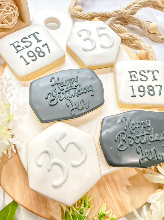 minimalist sugar cookies decorated with the number 35 and the words Happy Birthday