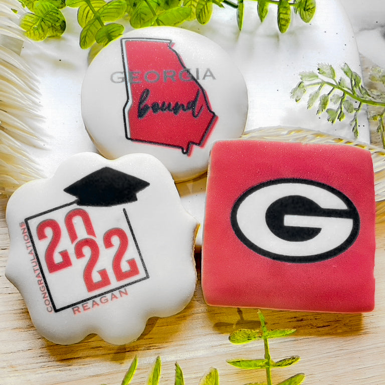 Custom Georgia Bulldogs graduation cookies featuring the Georgia 'G' logo, state outline, and celebratory "Congrats Grad" plaques, fully customizable.