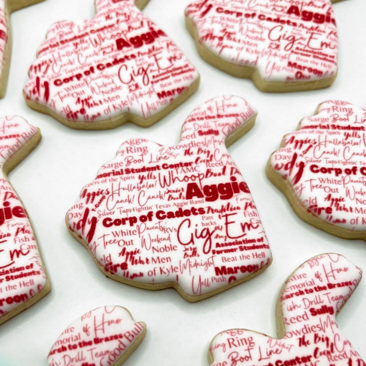 Custom Texas A&M Aggie Thumb graduation cookies featuring words and phrases representing the Aggie spirit, fully customizable.