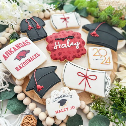Custom graduation cookies with Class of 2024 theme, including personalized name and school colors, featuring a mix of full-size and mini cookies with diplomas, graduation caps, and celebration designs.
