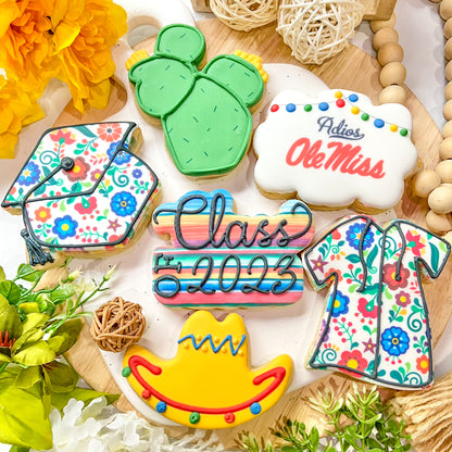 Fiesta-themed graduation cookies featuring colorful designs with a sombrero, cactus, and graduation cap.