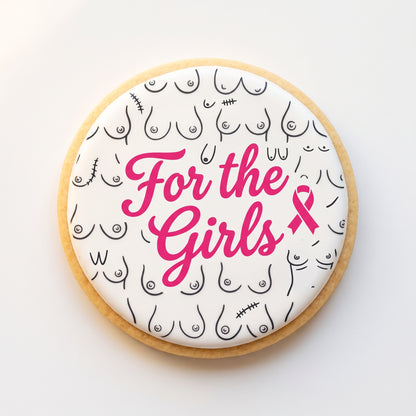 A round sugar cookie with an inclusive boobs line-art pattern background and bold hot pink 'For the Girls' script centered on top with a small pink ribbon.