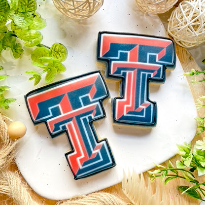 Texas Tech logo cookies with custom "T" designs and bold school colors.
