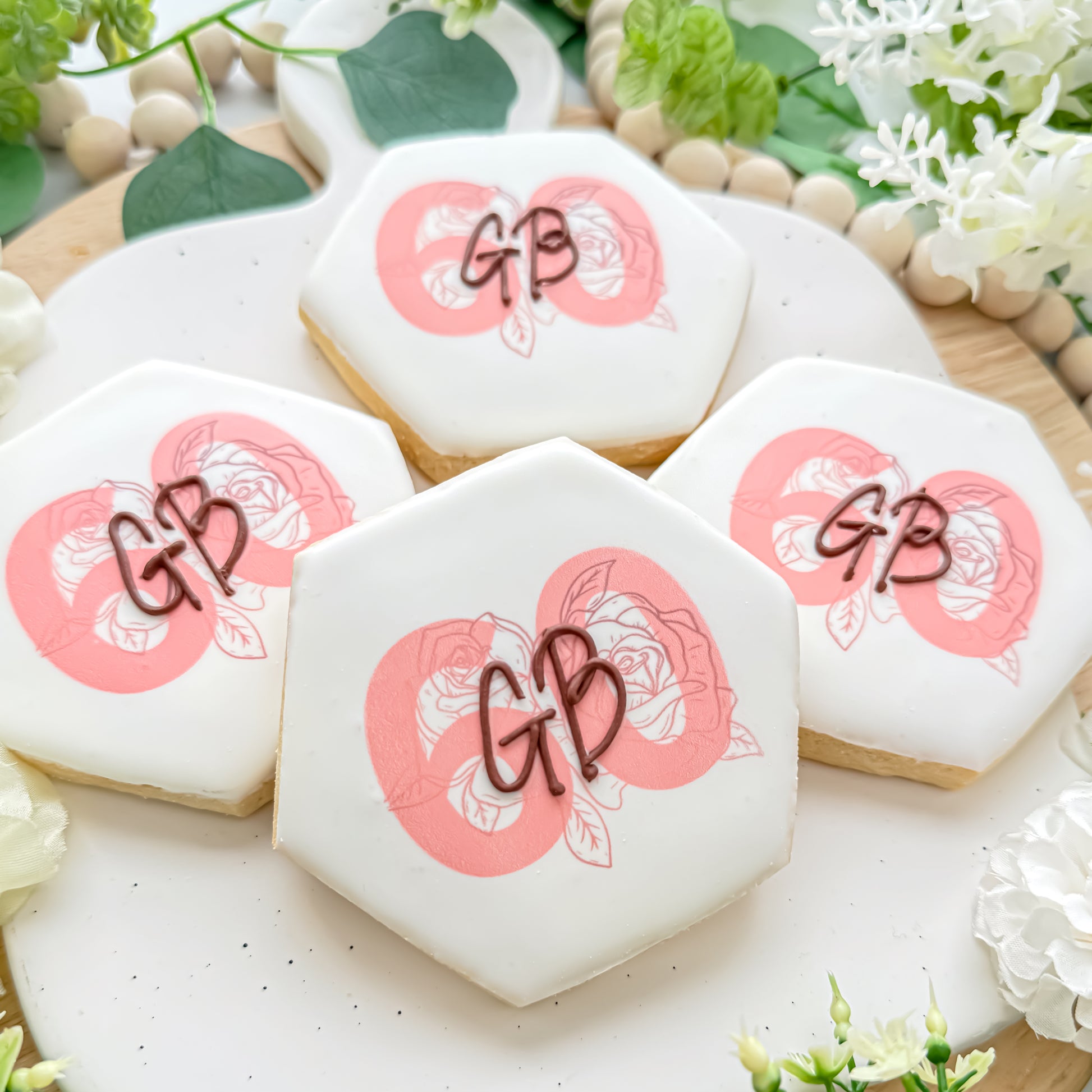 sugar cookies with the initials GB and floral decorations