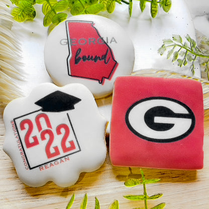 Custom Georgia Bulldogs graduation cookies featuring the Georgia 'G' logo, state outline, and celebratory "Congrats Grad" plaques, fully customizable.
